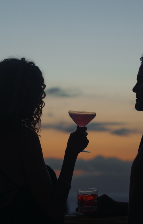 A couple enjoys cocktails at dusk