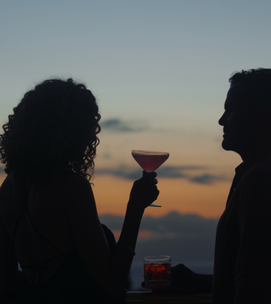 A couple enjoys cocktails at dusk